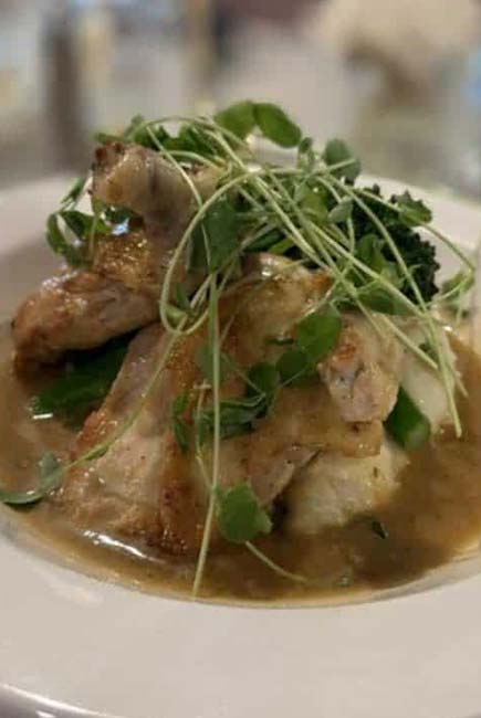 Chicken breast on mashed potatoes with gravy, served at our Marinette Restaurant & Event Venue.