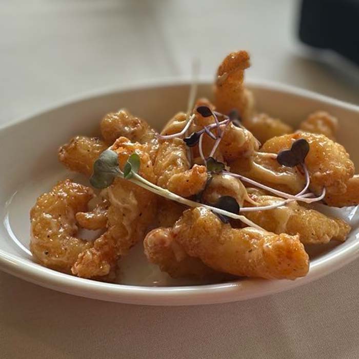 Creamy fried shrimp topped with microgreens, a Marinette Restaurant signature dish.