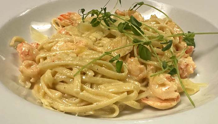 Fettuccine pasta with shrimp in creamy sauce, served at River’s Edge Supper Club.