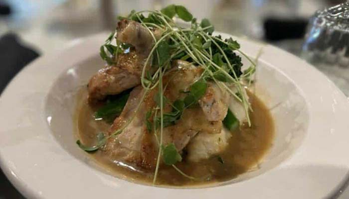 Chicken breast with gravy, mashed potatoes, and microgreens at River’s Edge Supper Club.